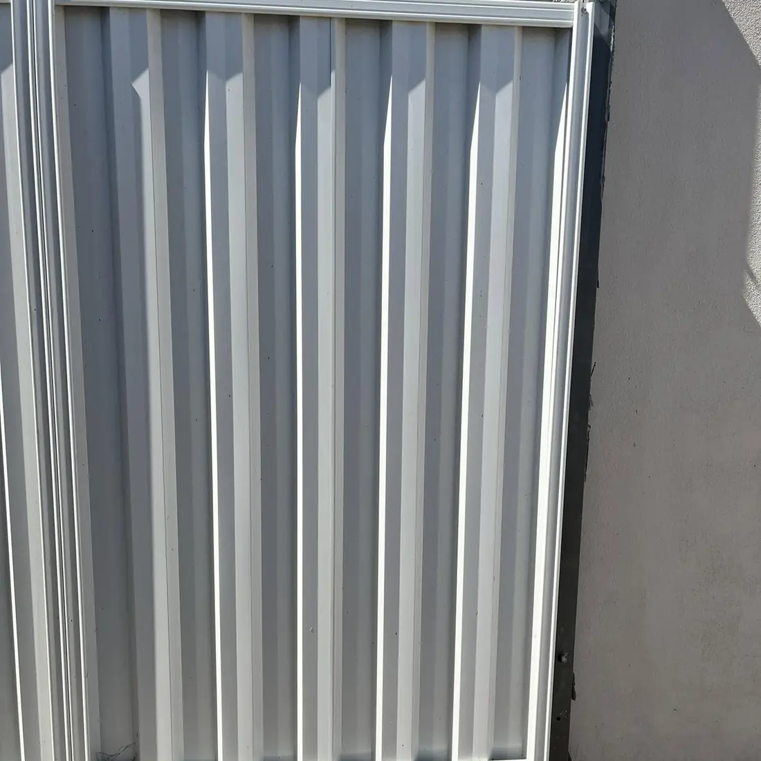 Close up of a grey Colorbond panel and post